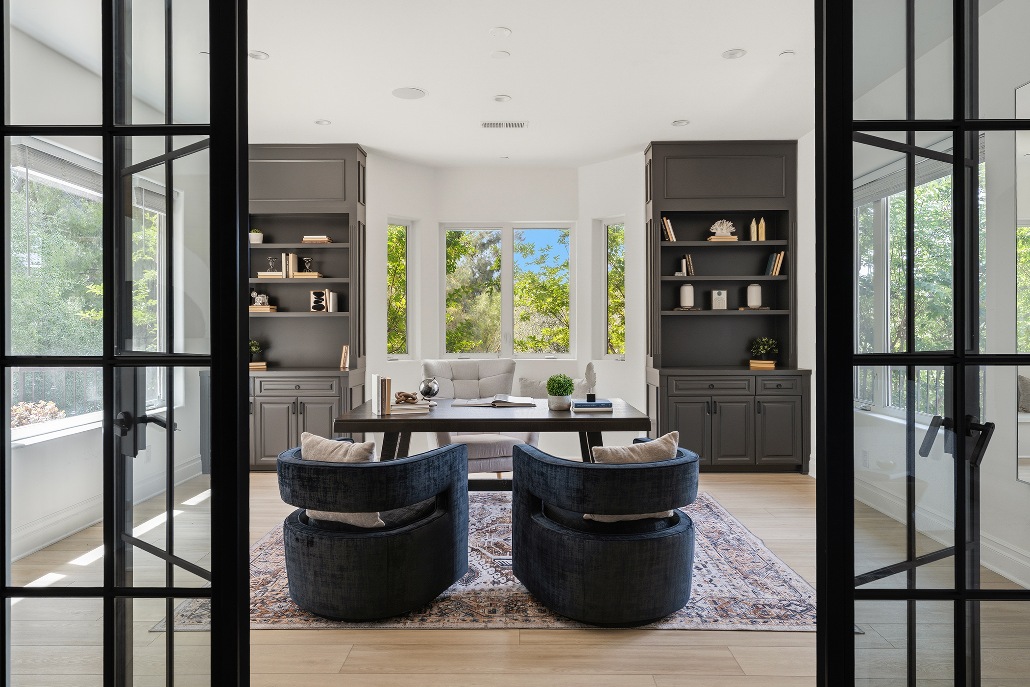 Bright study framed by dark built-in cabinetry